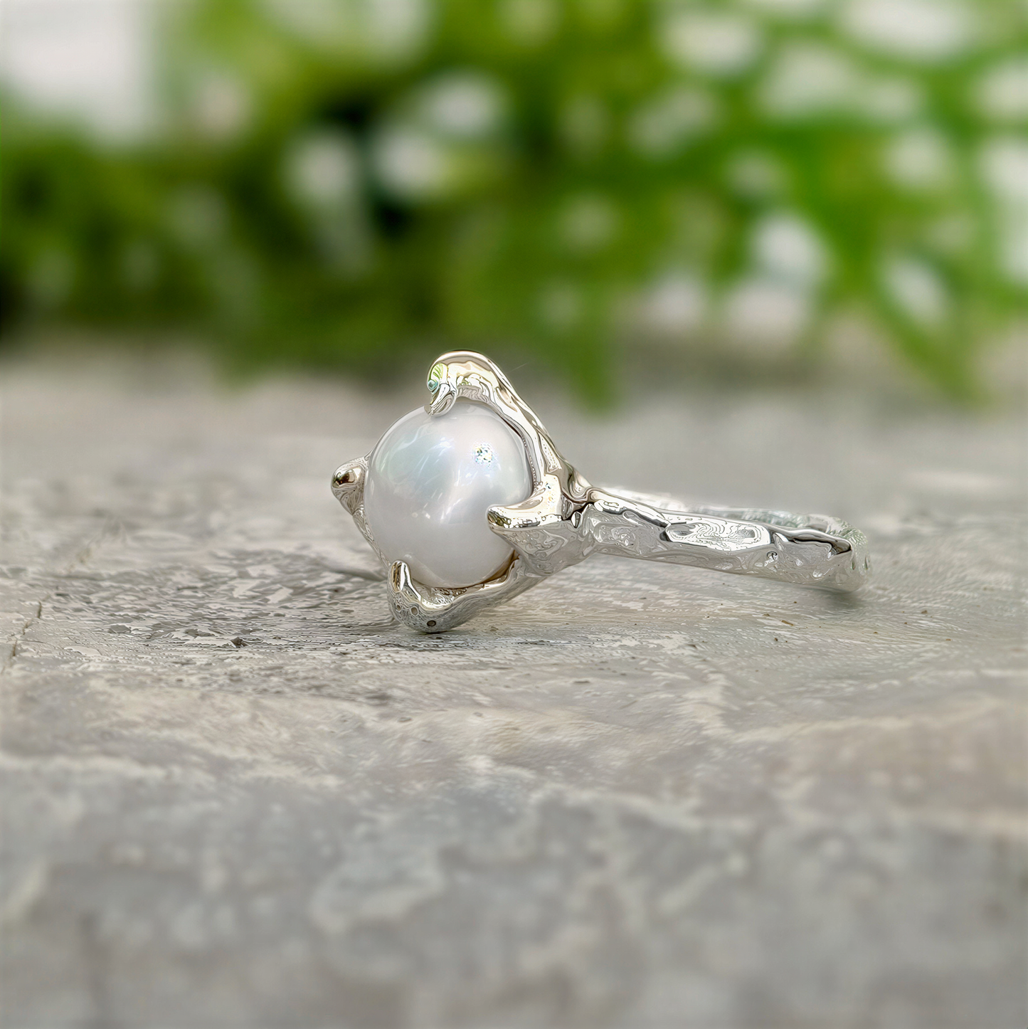 Textured sterling silver ring featuring a creamy-white Freshwater Keshi pearl, elegant and unique, perfect for simplicity lovers.