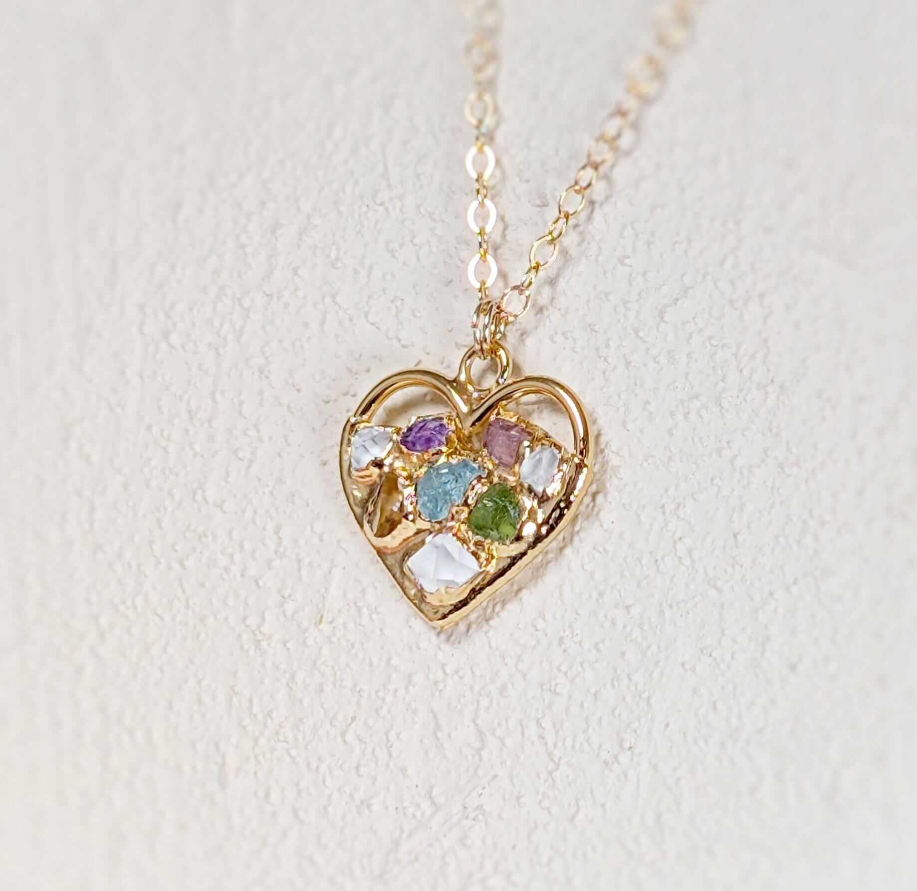 Heart-shaped necklace with birthstones, symbolizing family connections, in gold plating.