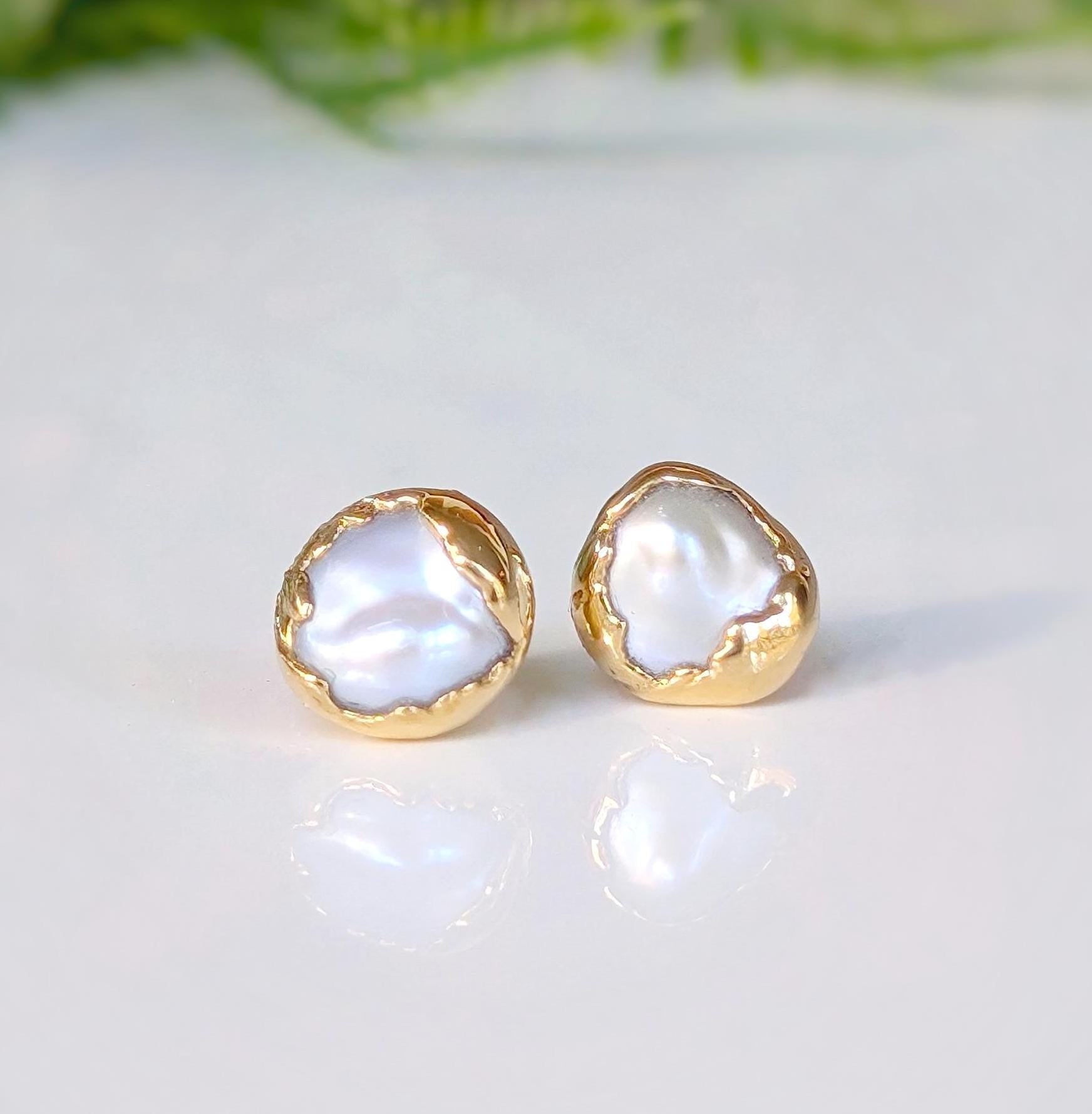 Gold freshwater pearl stud earrings from the 'Pea in a Pod' collection, showcasing unique creamy-white Keshi pearls.