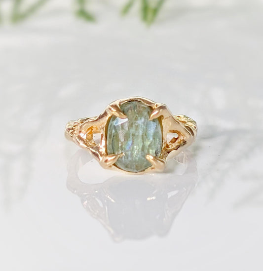 Solid 14k Gold textured ring featuring an oval Lime green Kyanite stone, showcasing unique artistry and elegance.