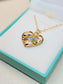 Heart-shaped gold necklace with colorful birthstones in a gift box, perfect personalized gift for mom.