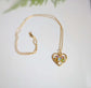 Heart-shaped necklace with colorful birthstones on a gold chain, perfect personalized gift for mom.