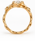 A gold ring with a large central Moissanite and intricate, organic designs around the edges.