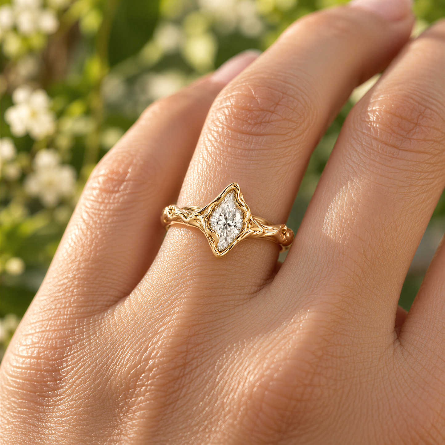 A close-up of a gold ring with a Moissanite set in the center, worn on a woman's hand against a blurred background of greenery.