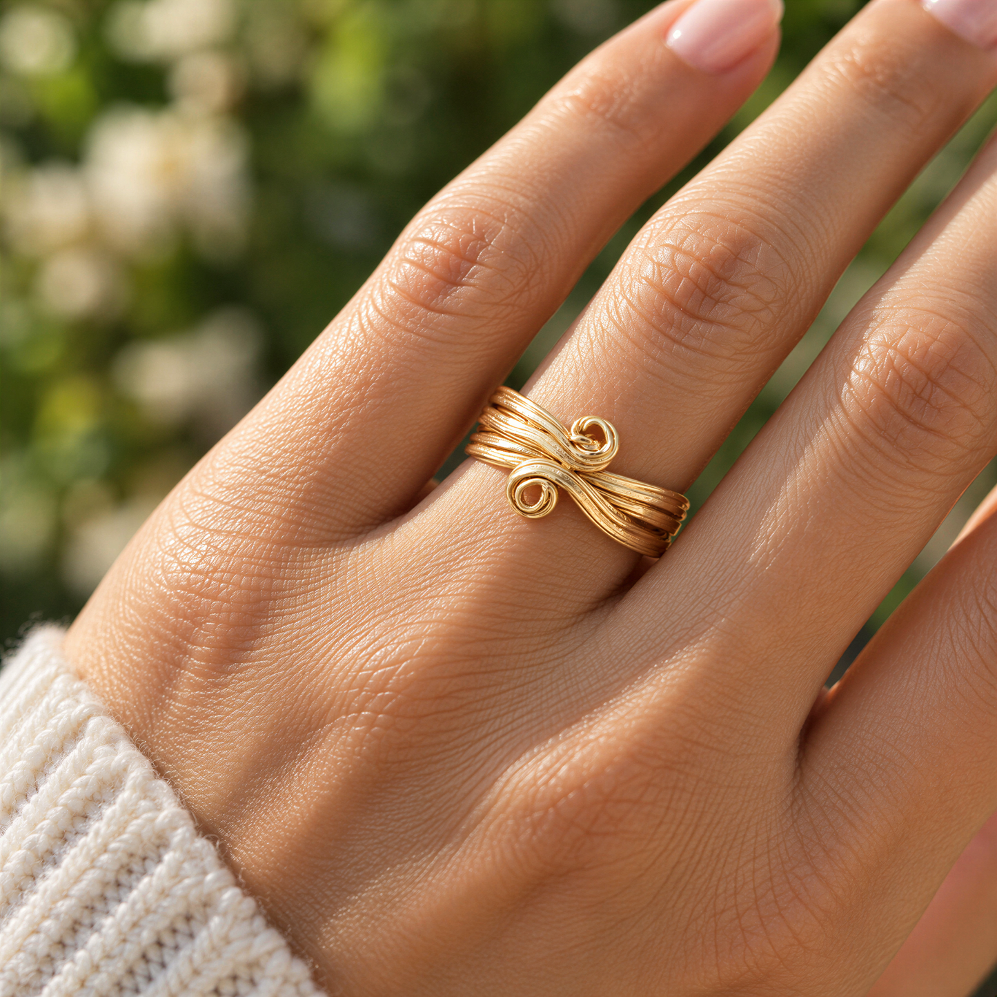 A close-up of a person's hand wearing a gold ring with a Molten textured design.
