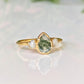 Pear-shaped Moss Agate engagement ring with raw Herkimer diamonds on a 14k gold band.