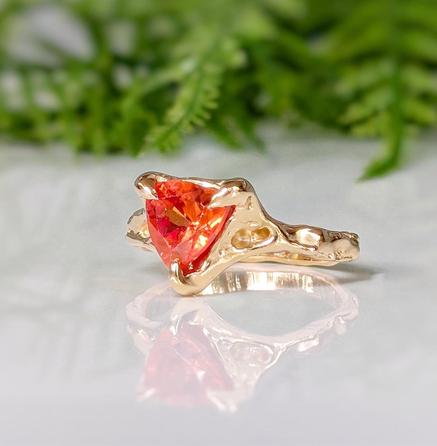 Orange Sapphire trilliant cut ring in solid 14k gold with textured band, showcasing unique handcrafted design.