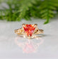 Orange Sapphire trilliant cut ring in solid 14k gold with unique molten texture, perfect for engagement or special gift.
