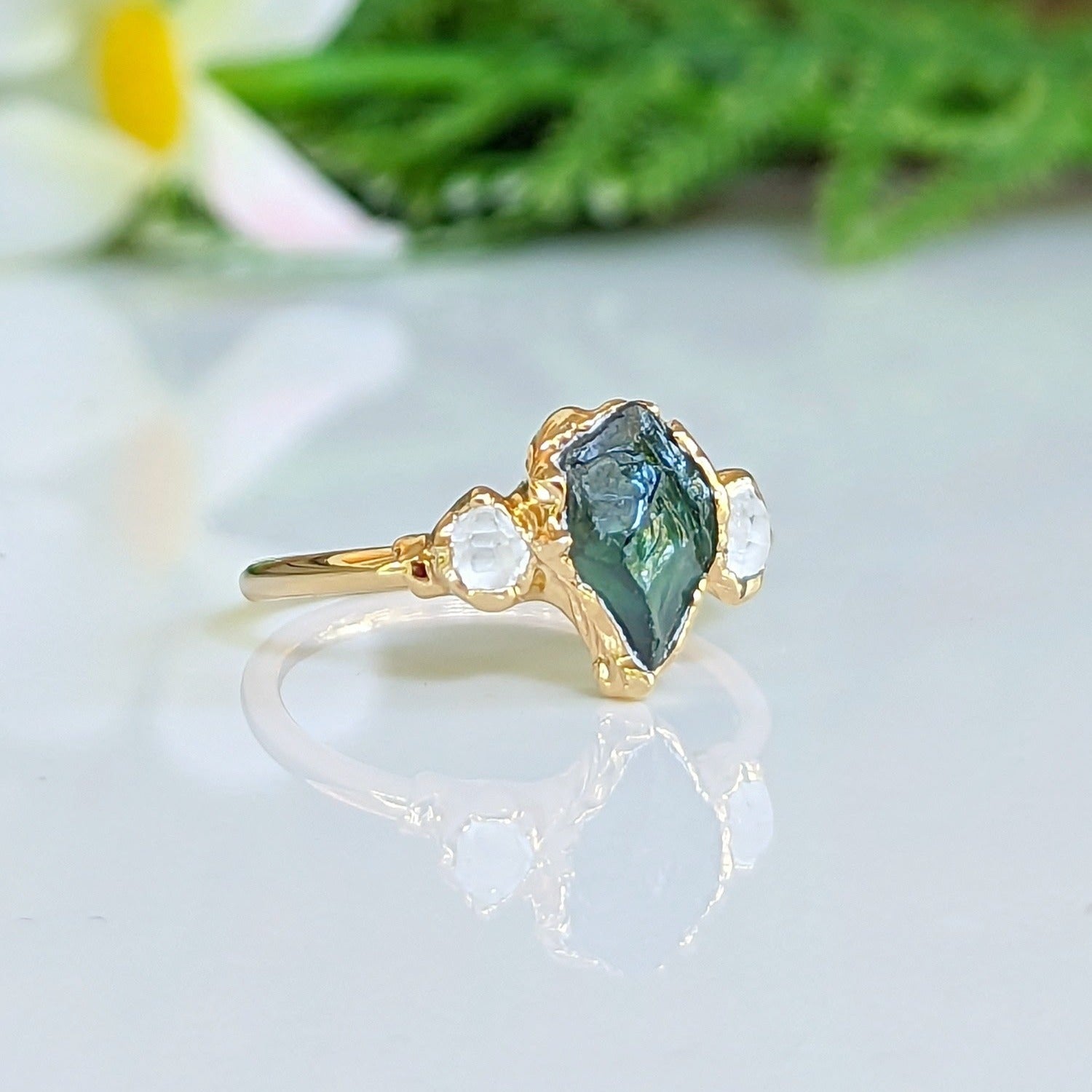 Raw green sapphire and herkimer diamond engagement ring on gold band, unique handcrafted jewelry for special occasions.