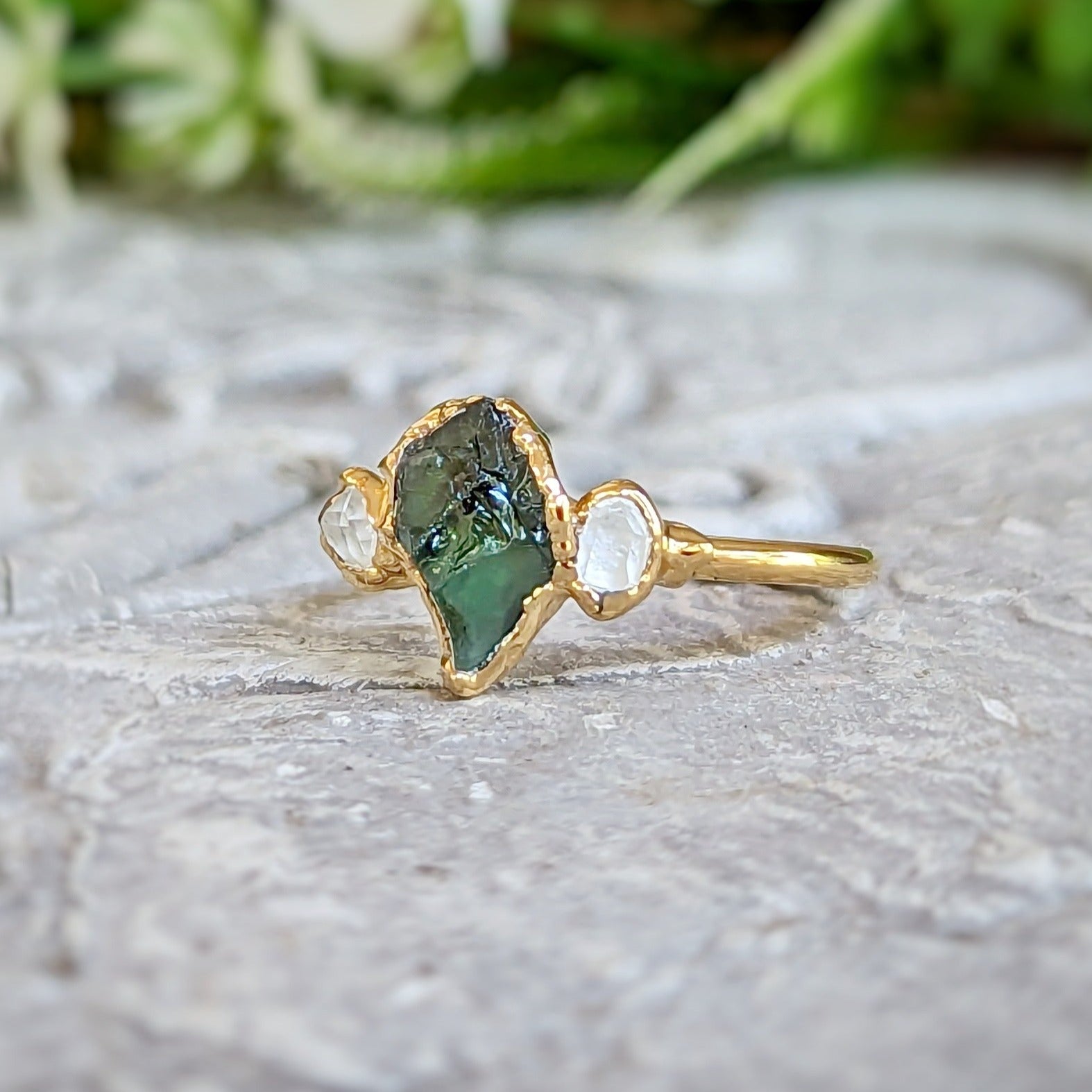 Handcrafted raw green Sapphire engagement ring with Herkimer diamond accents, set in yellow gold.
