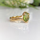 Handcrafted gold Peridot ring with an organic textured band, showcasing a stunning rose cut green gemstone.