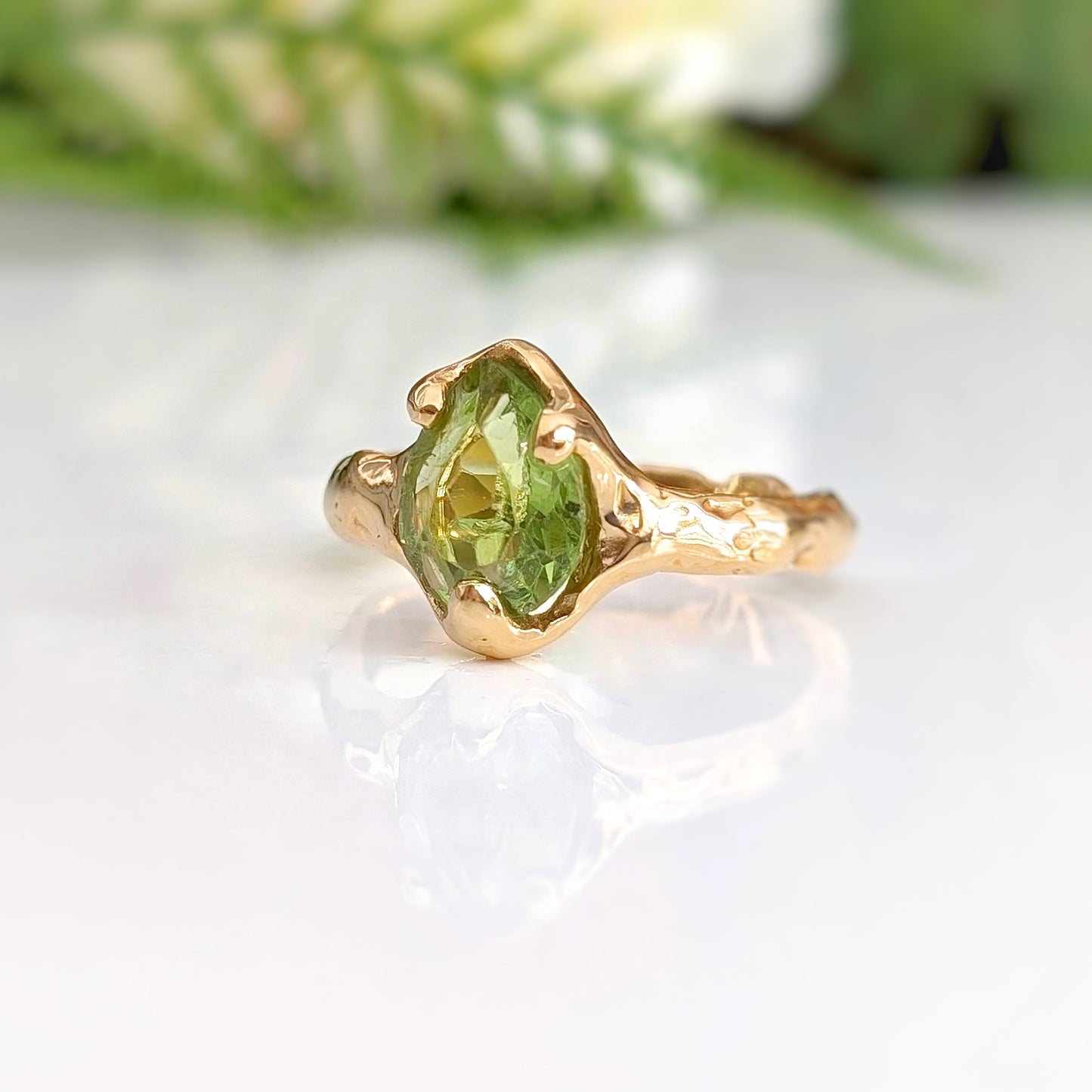 Handcrafted sterling silver Peridot ring with organic textured band, showcasing rose cut gemstone, perfect for August birthdays.