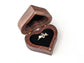 Heart-shaped wooden ring box with a ring inside, perfect for jewelry gifting.
