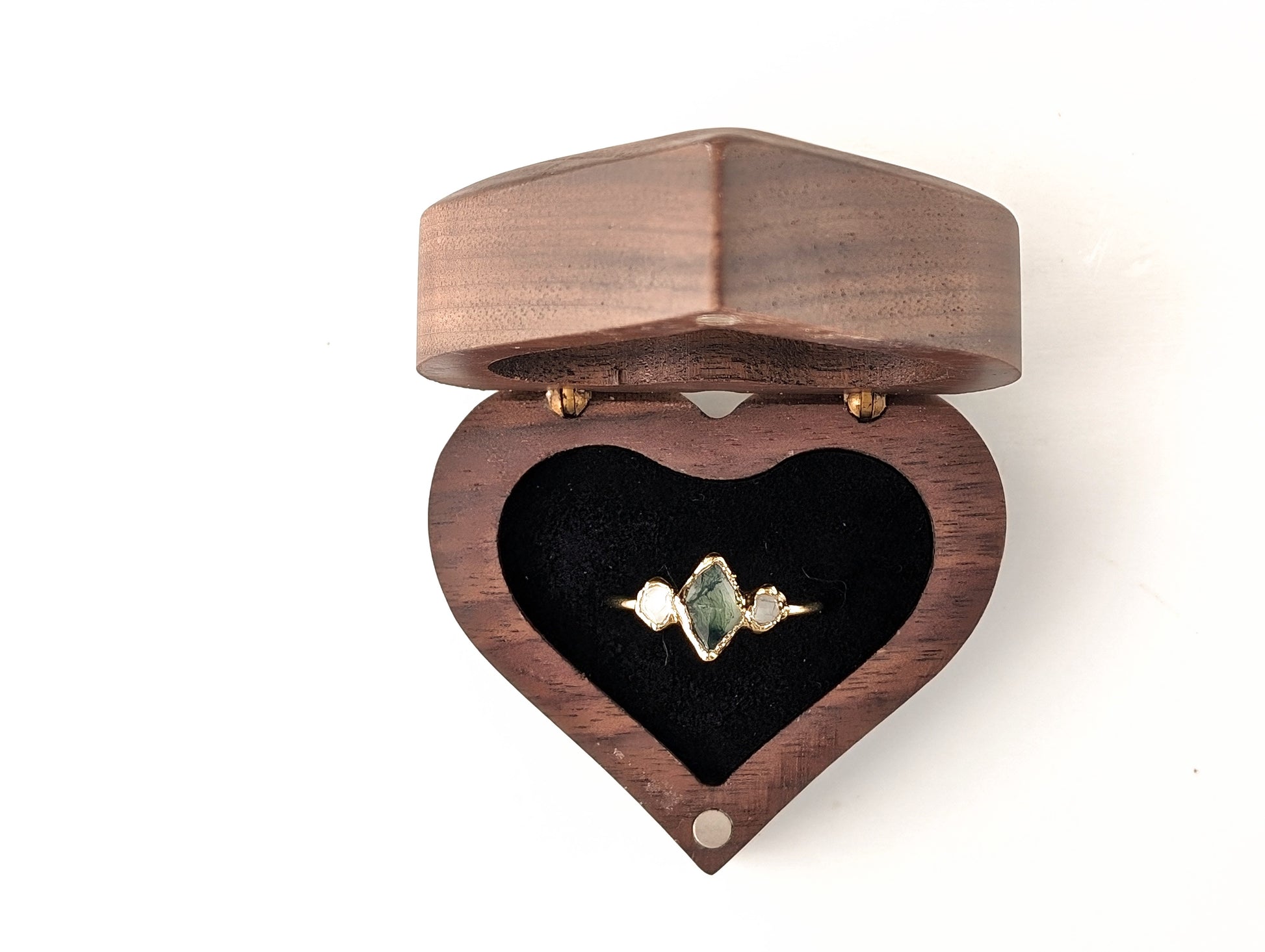 Heart-shaped wooden ring gift box with a gold and gemstone ring inside, perfect for gifting engagement rings.