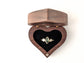 Heart-shaped wooden ring gift box with a gold and gemstone ring inside, perfect for gifting engagement rings.