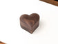 Heart-shaped wooden ring box made of walnut, designed as a gift box for engagement rings.