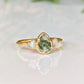 Pear-shaped Moss Agate engagement ring with raw Herkimer diamonds on a 14k gold band.