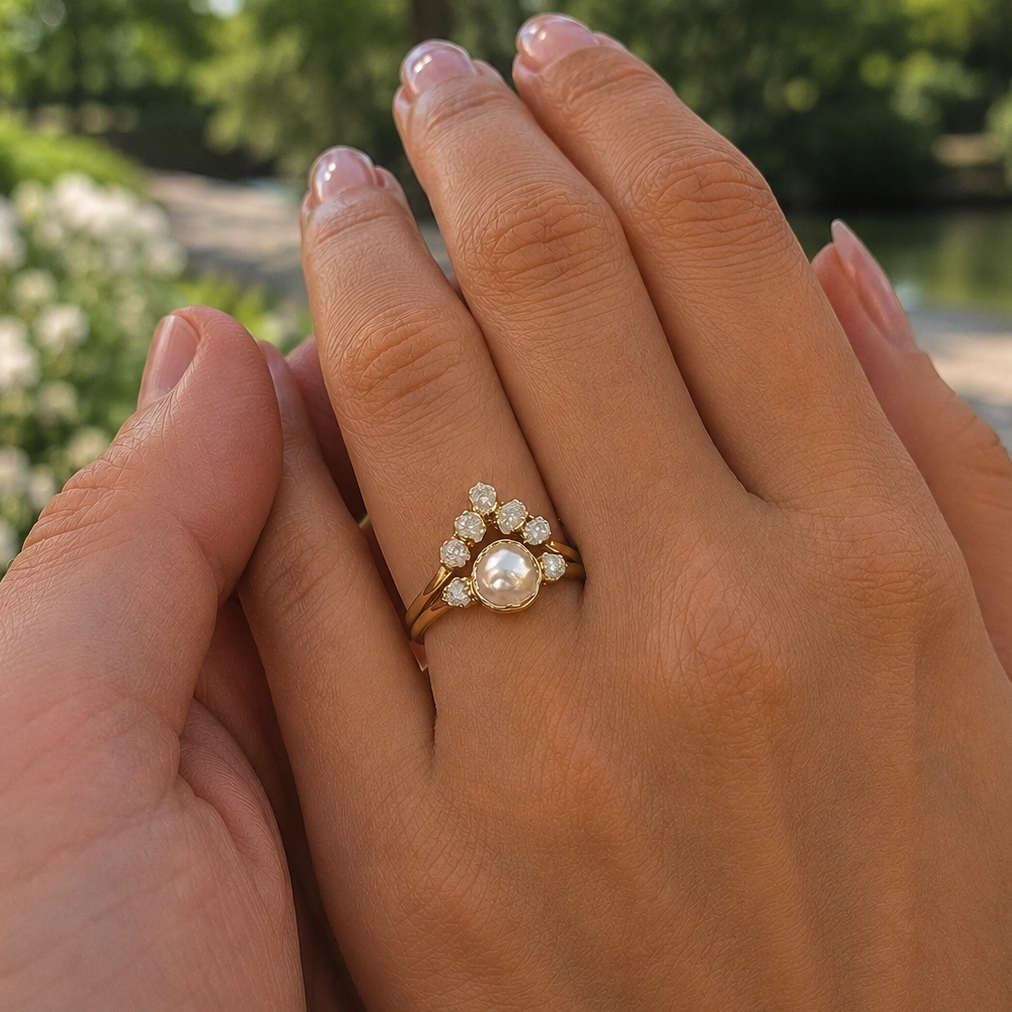 Woman wearing a Gold Pearl and diamond ring set - a man's hand is holding her hand