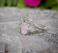 Silver diamond ring with pink Morganite on a textured surface