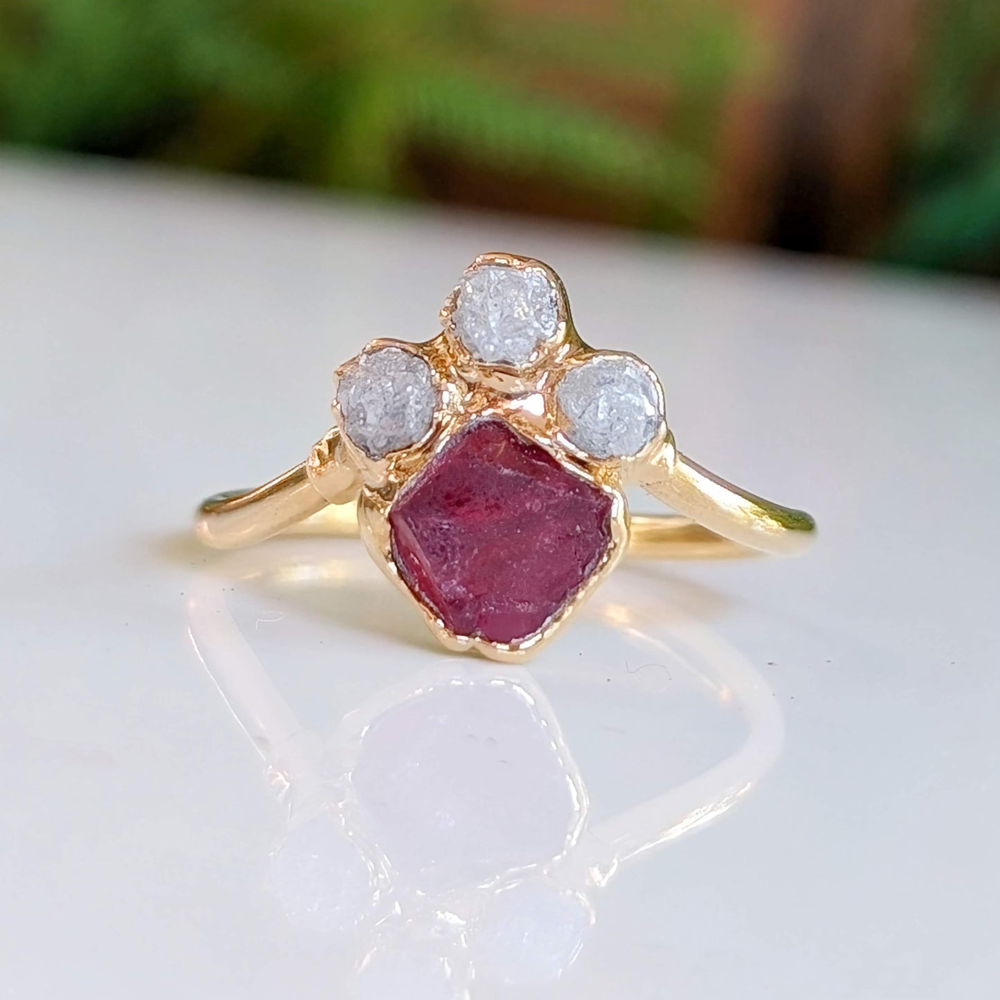 Gold Chevron engagement ring featuring raw Pink Spinel and three raw diamonds, handcrafted and ethically sourced.