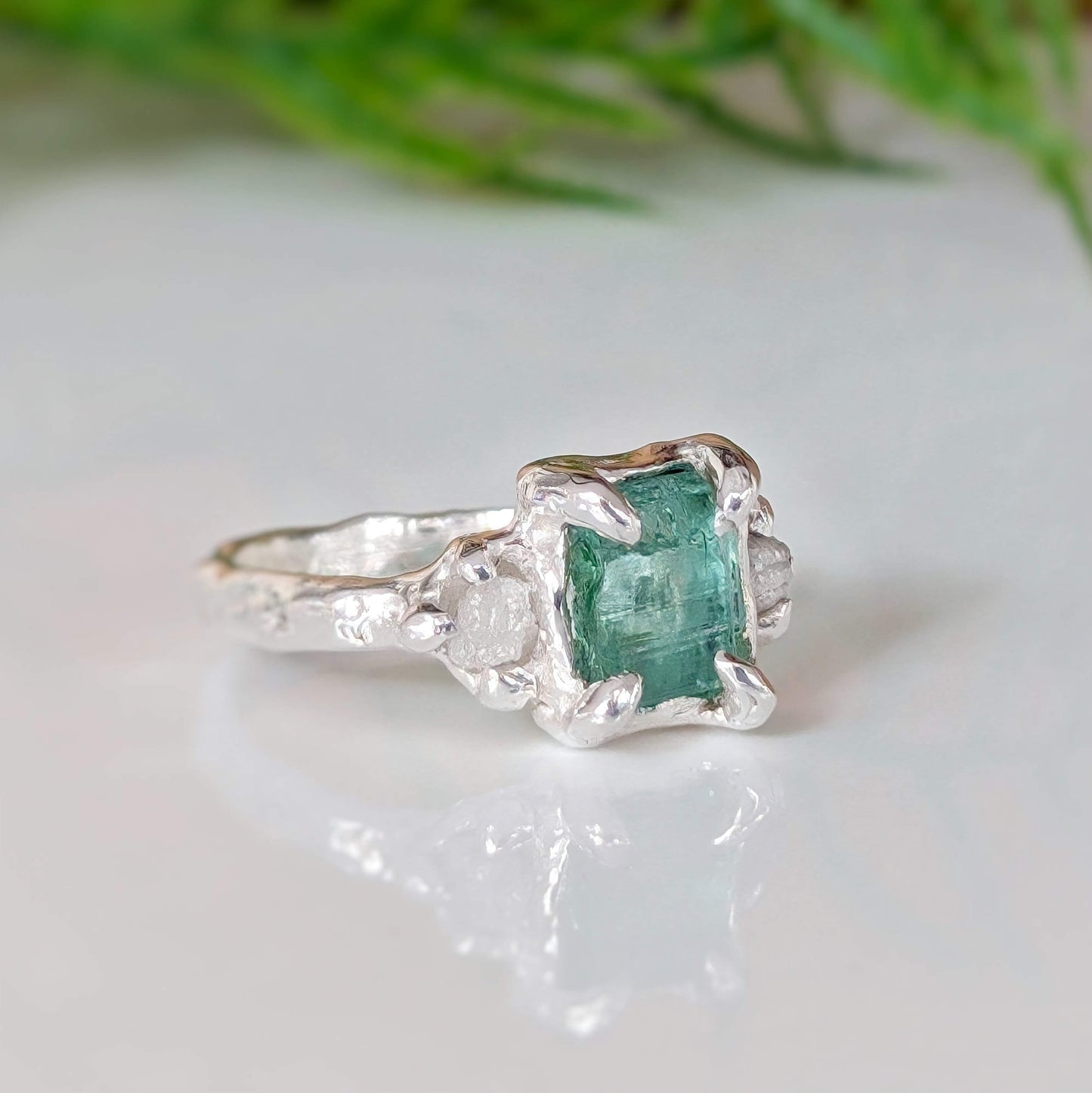 Raw Emerald and diamond engagement ring in solid sterling silver with a nature-inspired design.