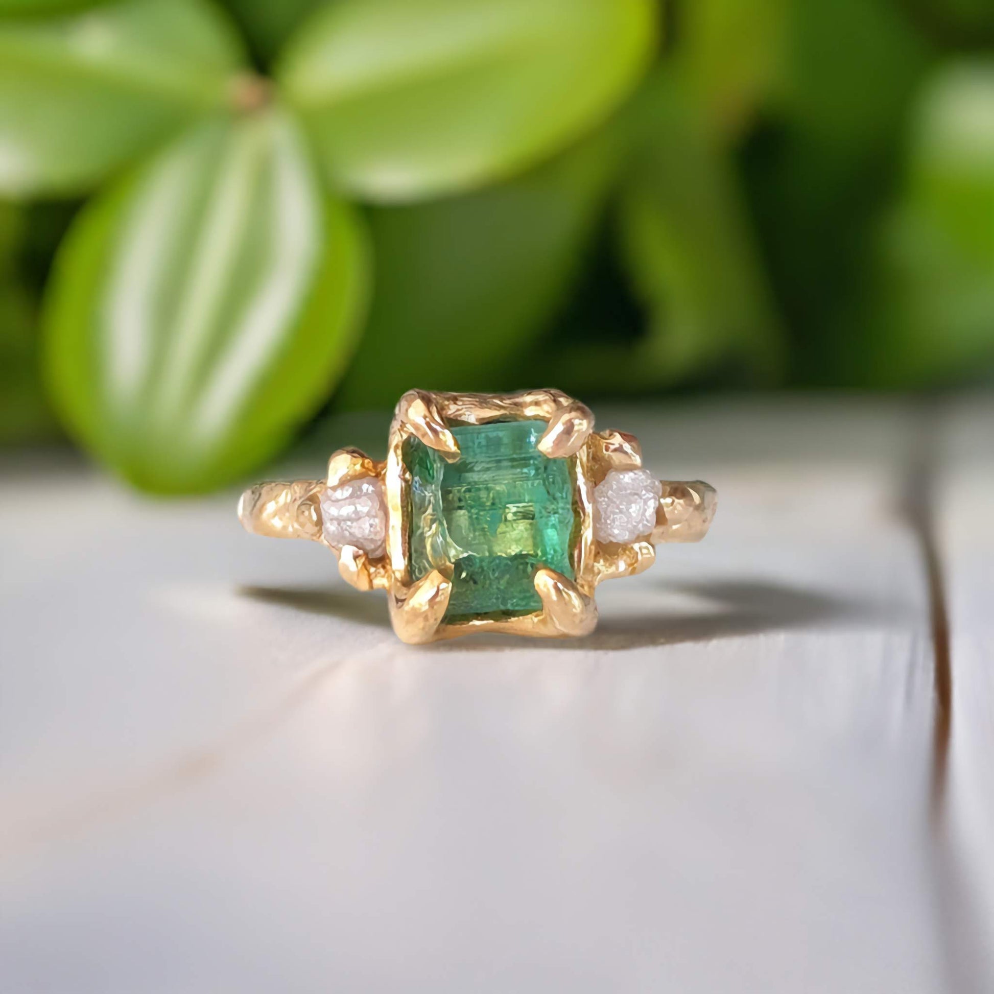 Raw emerald and diamond engagement ring in solid 14k gold, featuring mint green emerald and conflict-free diamonds.