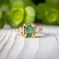 Raw emerald and diamond engagement ring in solid 14k gold with nature-inspired design, showcasing mint green emerald and two diamonds.