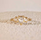 Rustic 14k gold engagement ring featuring heart-shaped Salt & Pepper diamond and two smaller diamonds.