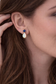 Blue Sapphire and Opal stud earrings in Gold worn by a woman, showcasing their dainty and elegant design.