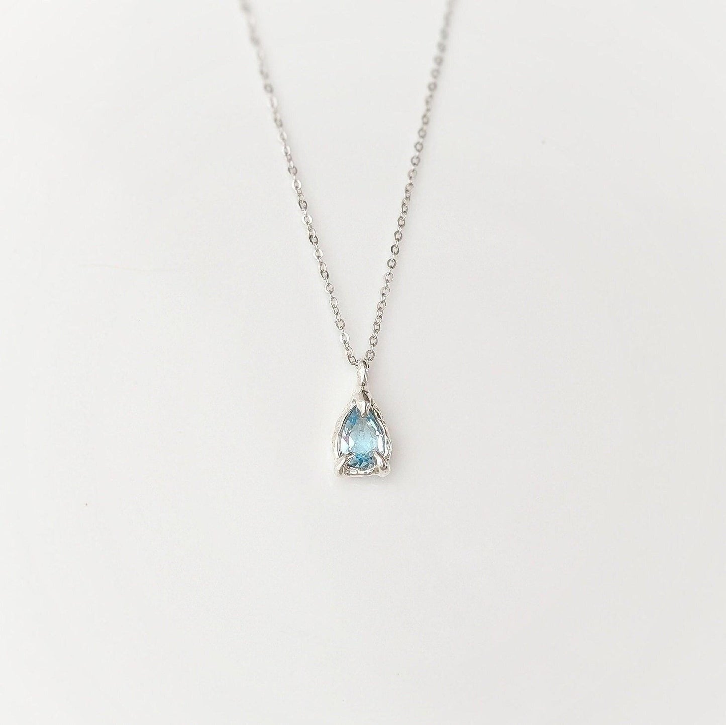 A Pear shape natural Aquamarine pendant set on a Sterling Silver chain
