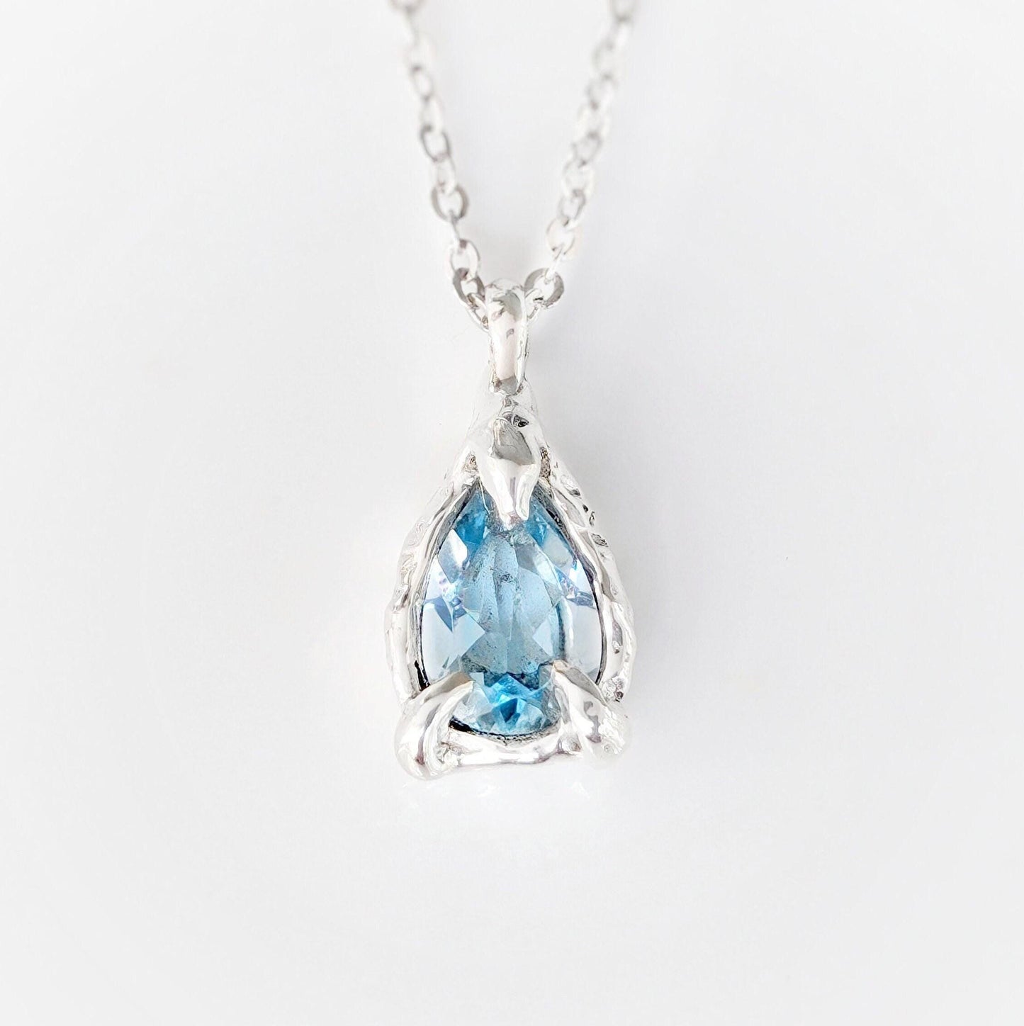A Pear shape natural Aquamarine pendant set on a Sterling Silver chain