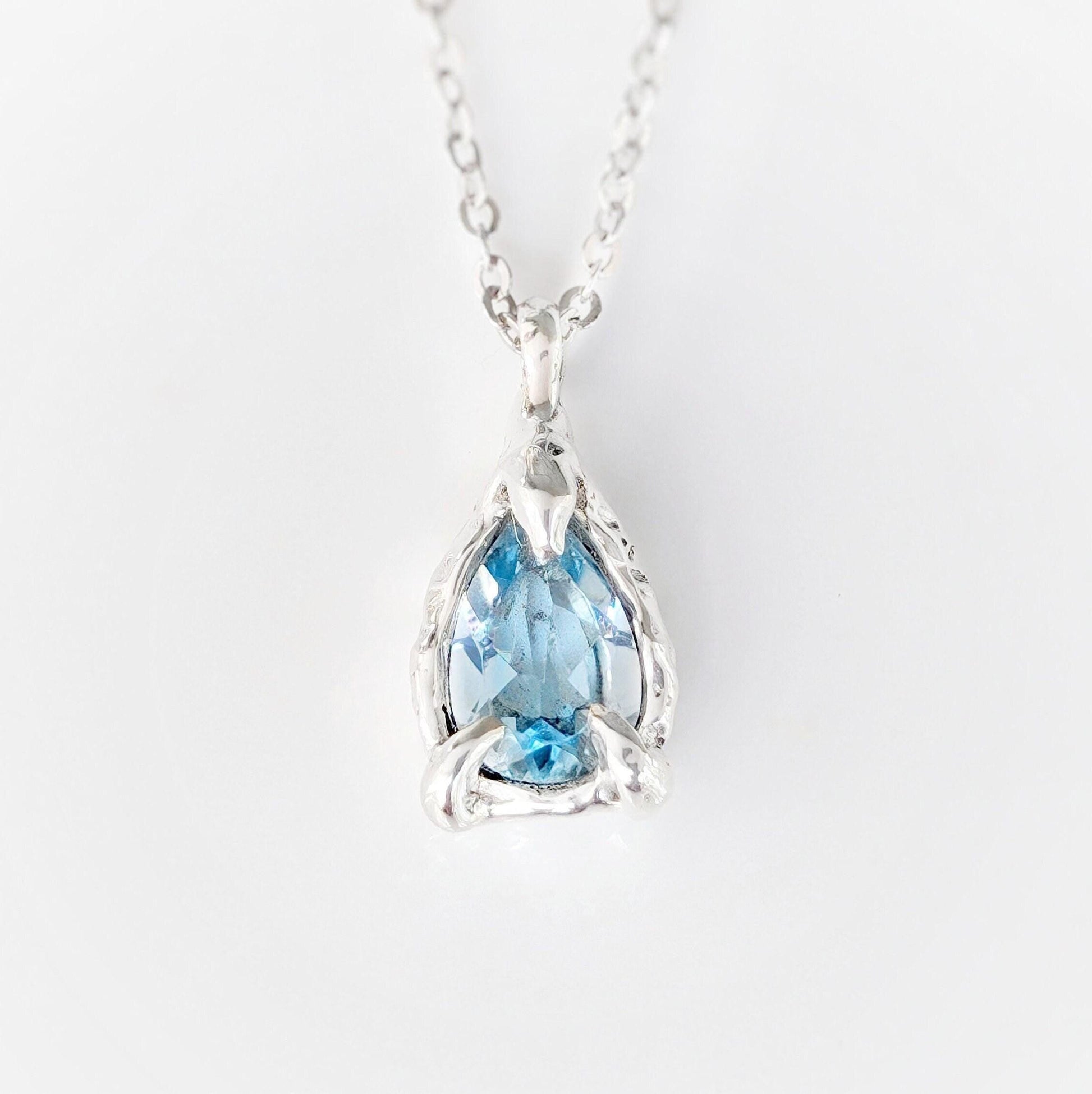 A Pear shape natural Aquamarine pendant set on a Sterling Silver chain