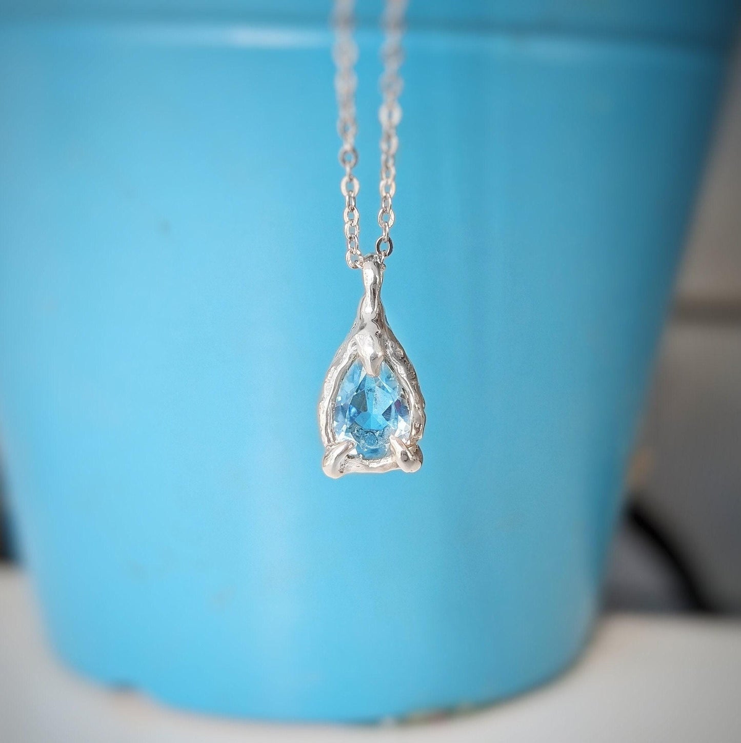 A Pear shape natural Aquamarine pendant set on a Sterling Silver chain