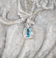 close-up aquamarine gemstone pendant in sterling silver