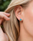 A woman wearing a square shape flashy blue & green Opal stud earring in Gold organic setting