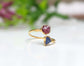 Toi et Moi raw gemstone ring featuring pink and blue gemstones in a gold setting, symbolizing love and friendship.