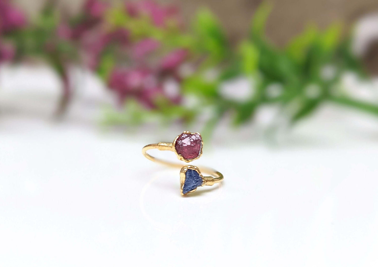 Toi et Moi raw gemstone ring featuring a pink and blue gemstone set in elegant gold ring design.
