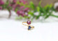 Toi et Moi raw gemstone ring featuring a pink and blue gemstone set in elegant gold ring design.