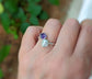 Toi et Moi raw gemstone ring featuring a purple and a blue stone on a hand, symbolizing love and family.