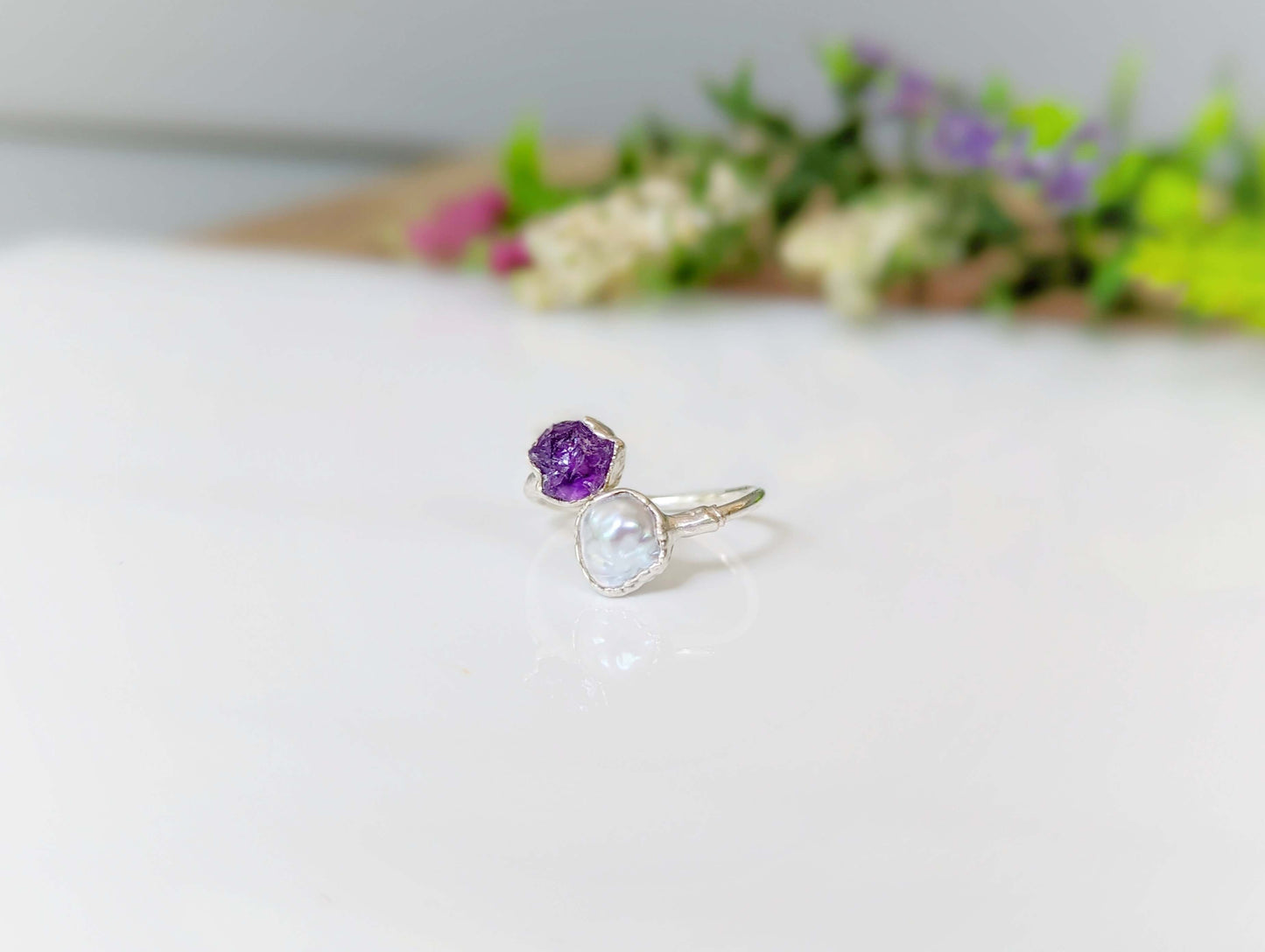 Toi et Moi raw gemstone ring featuring a purple and a clear stone, perfect for family birthstone personalization.