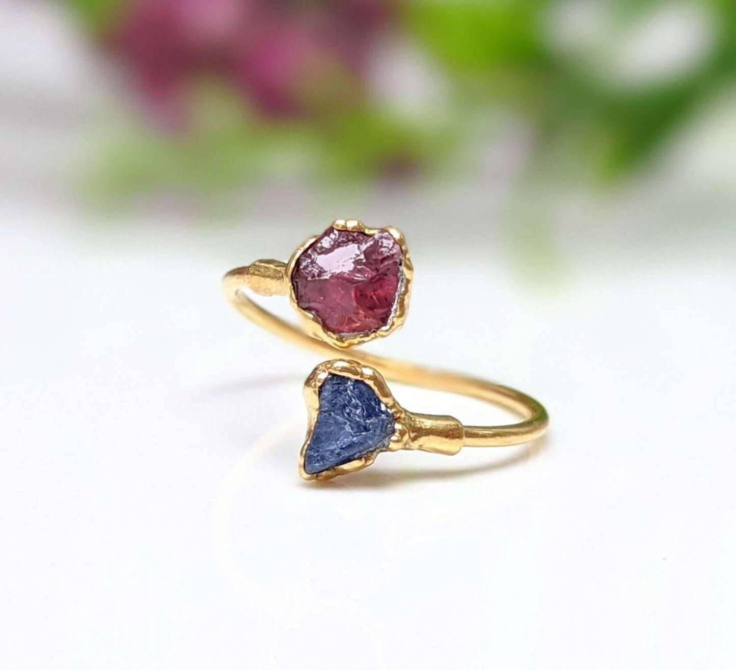 Toi et Moi raw gemstone ring featuring pink and blue raw gemstones set in gold, symbolizing love and friendship.