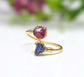 Toi et Moi raw gemstone ring featuring pink and blue raw gemstones set in gold, symbolizing love and friendship.