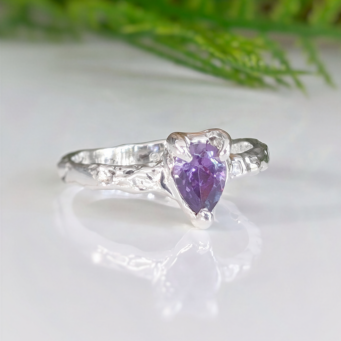 Amethyst engagement ring in solid sterling silver with organic textured band and pear-shaped crystal.