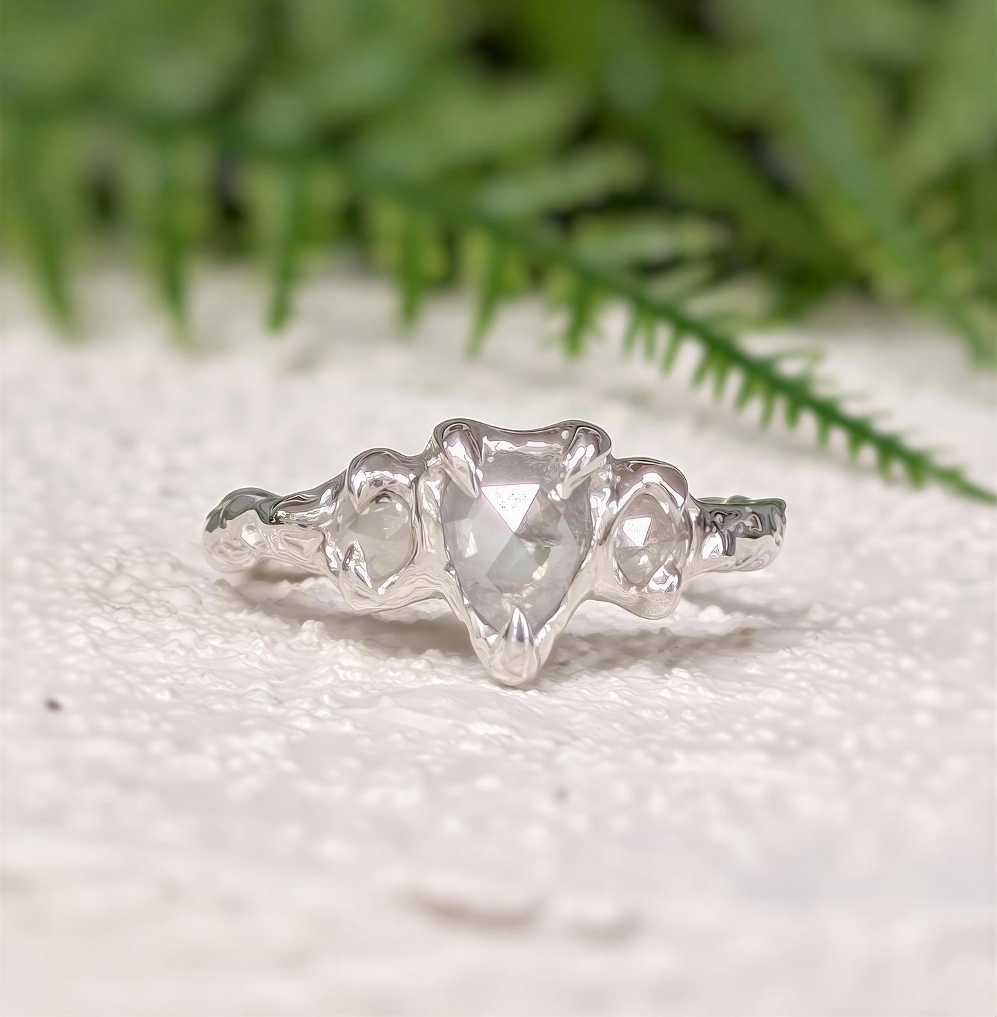 Rustic sterling silver engagement ring featuring a unique salt and pepper diamond, set on a textured band.