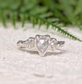 Rustic sterling silver engagement ring featuring a unique salt and pepper diamond, set on a textured band.