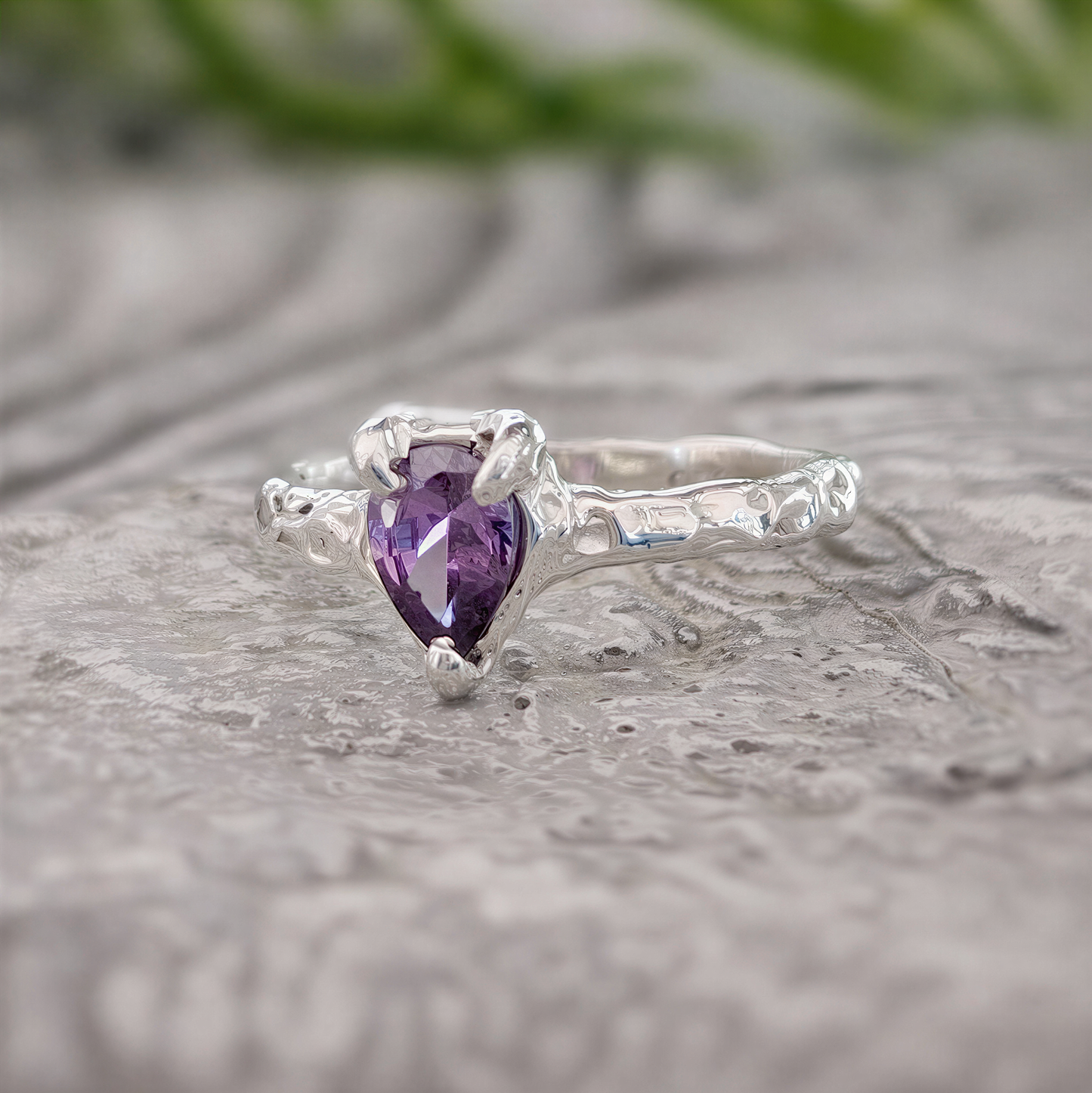 Amethyst engagement ring in solid sterling silver with a pear-shaped purple gemstone.