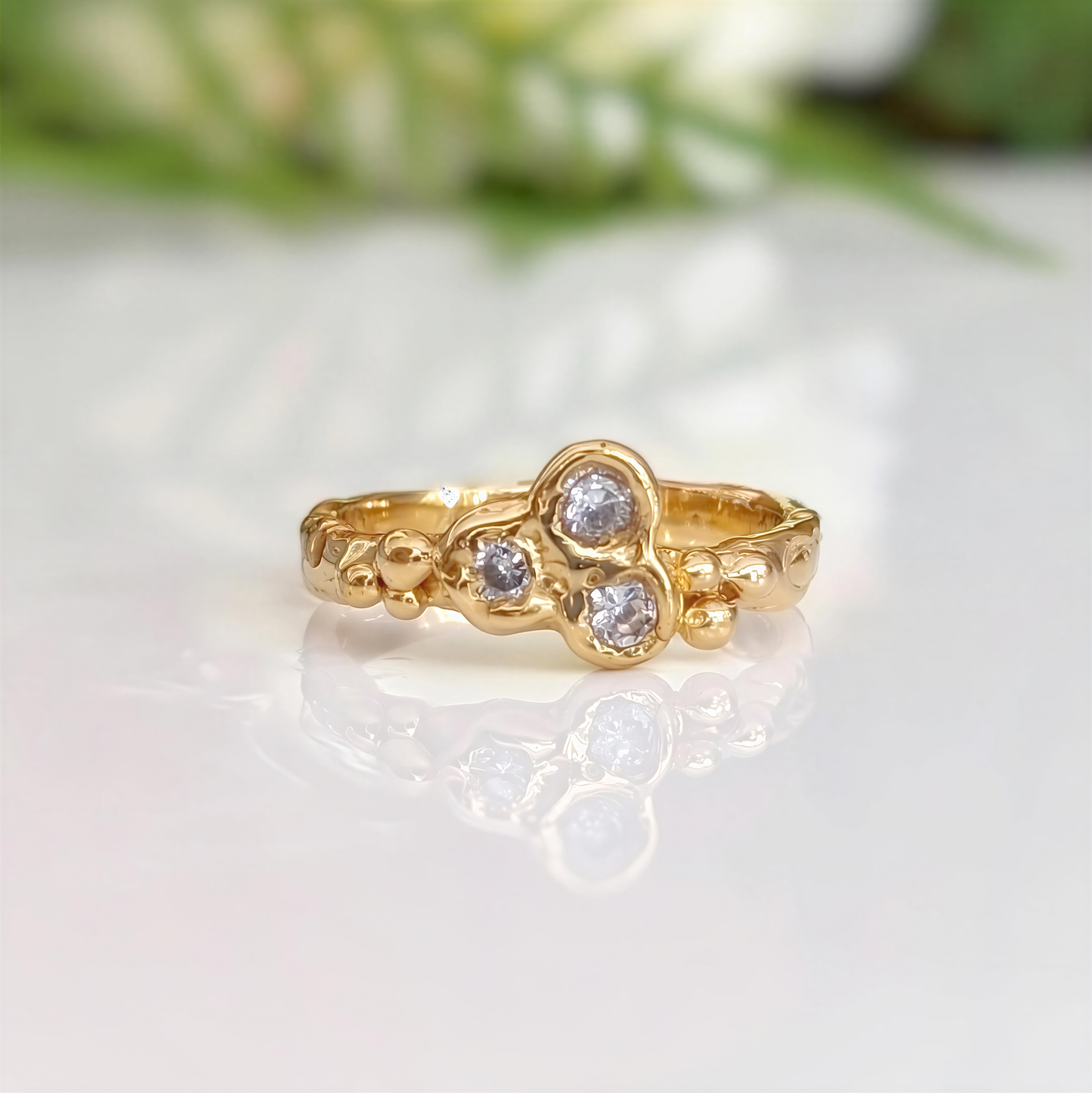 Cubic Zirconia cluster ring in Solid 14k Gold, featuring three sparkling stones on an organic textured band.