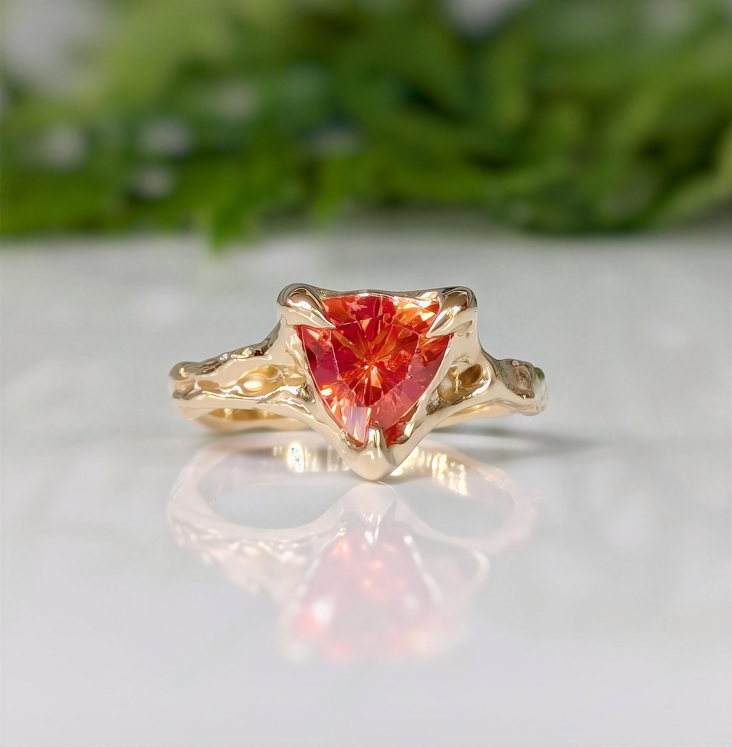 Orange sapphire trilliant cut ring in solid 14k gold with a textured organic band, handcrafted design.