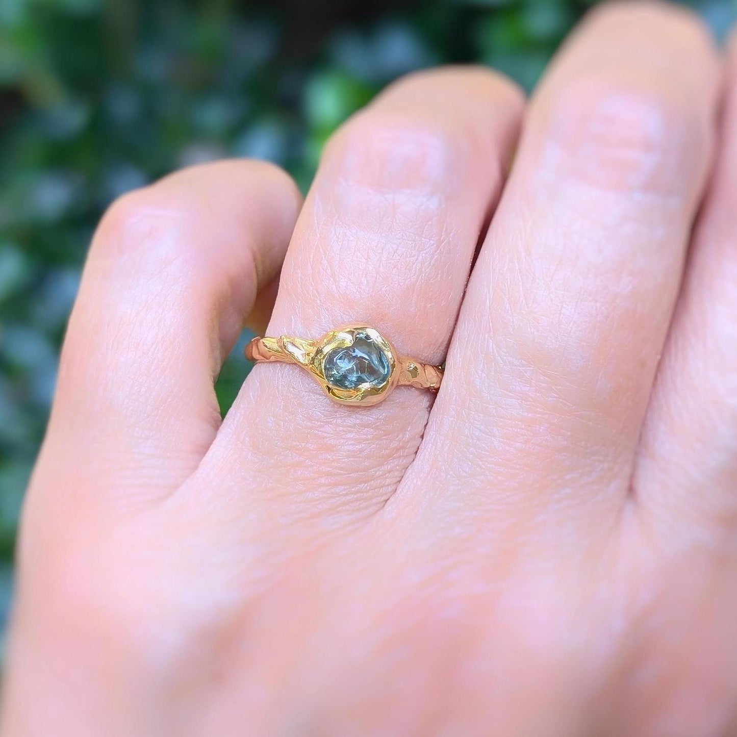 Teal Australian Sapphire ring in solid 14k gold, showcasing unique pod design on textured band.