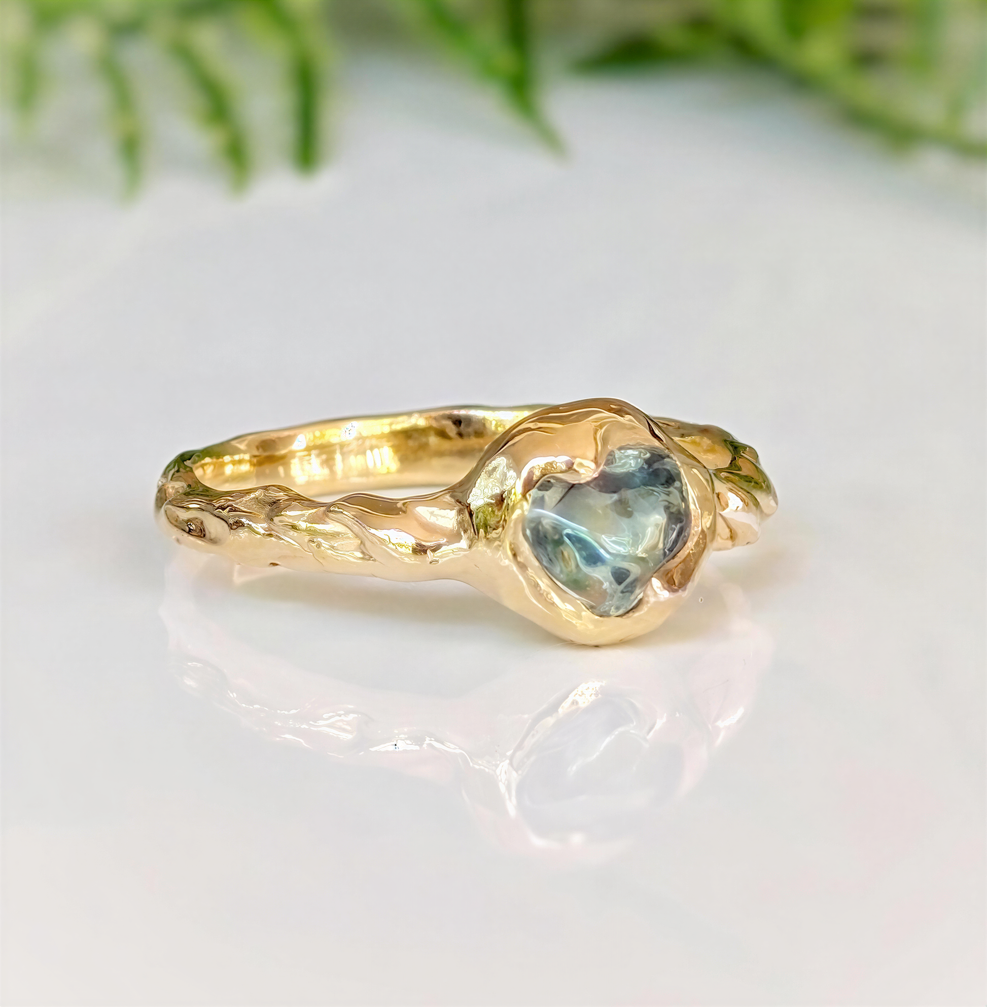 Unique Australian Sapphire ring in solid 14k gold, featuring a heart-shaped teal sapphire on a textured band.